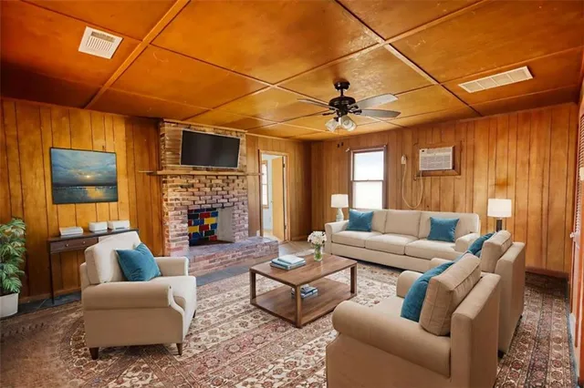 a living room with furniture a fireplace and a flat screen tv