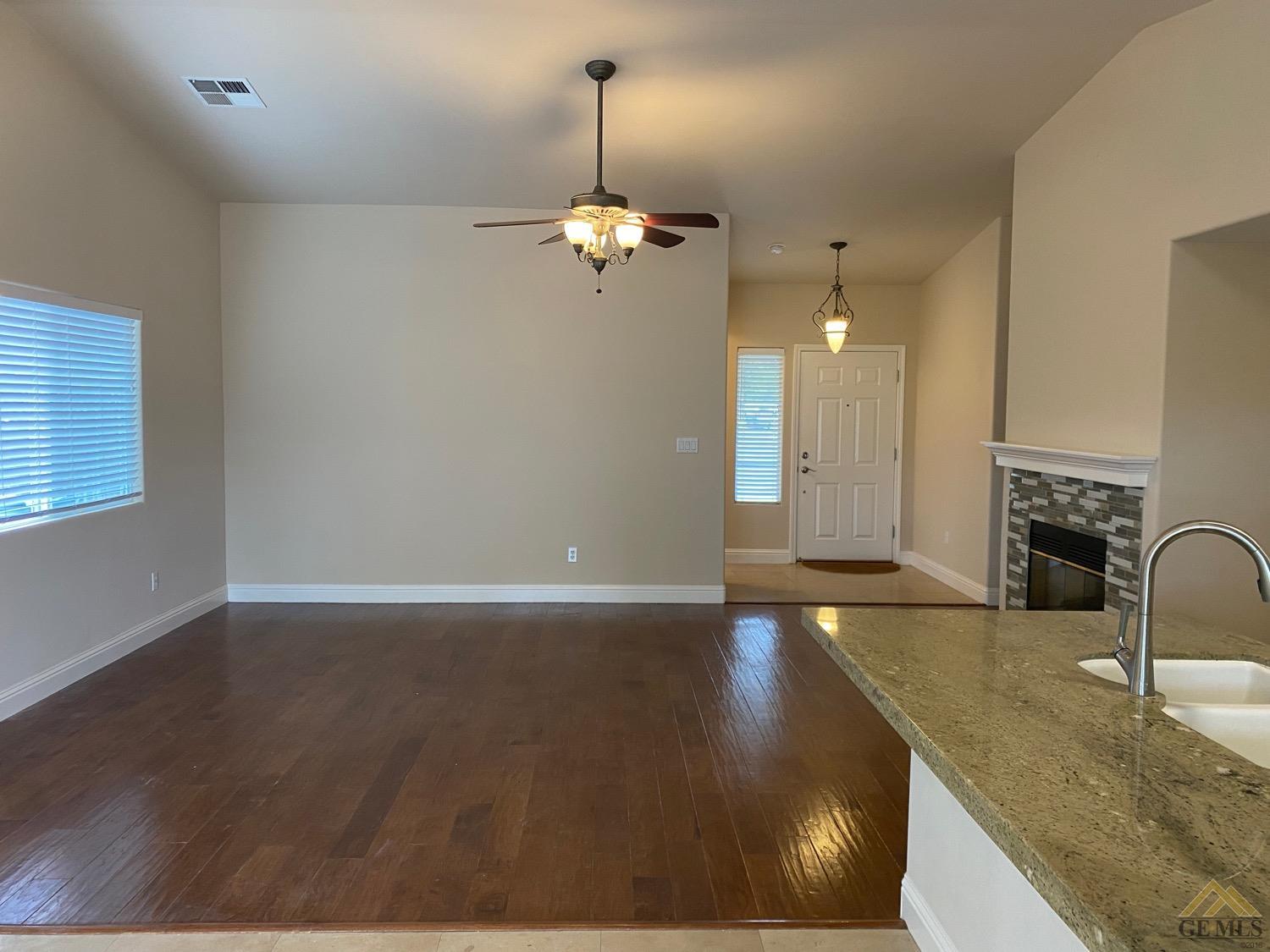 Undisclosed Address Bakersfield, CA 93311 - Photo 4 of 8 a view of a kitchen with granite countertop a sink cabinetry and a chandelier