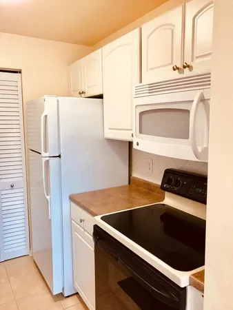 a kitchen with a stove and a refrigerator