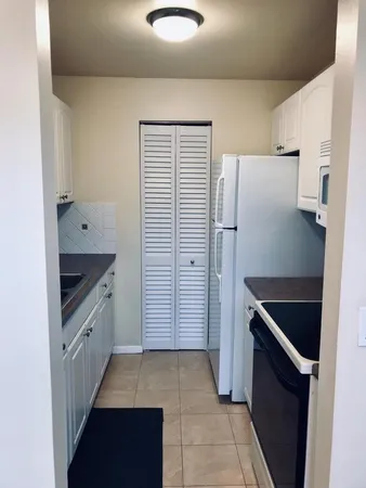 a kitchen with a cabinets and white stove