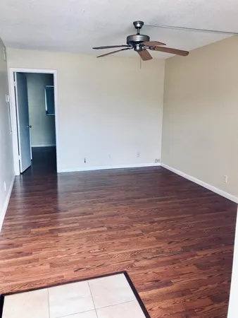 a view of a room with wooden floor
