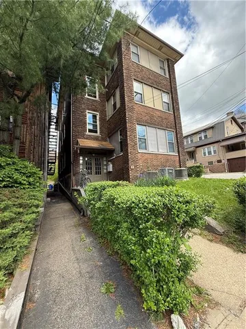 a view of a brick house with a yard