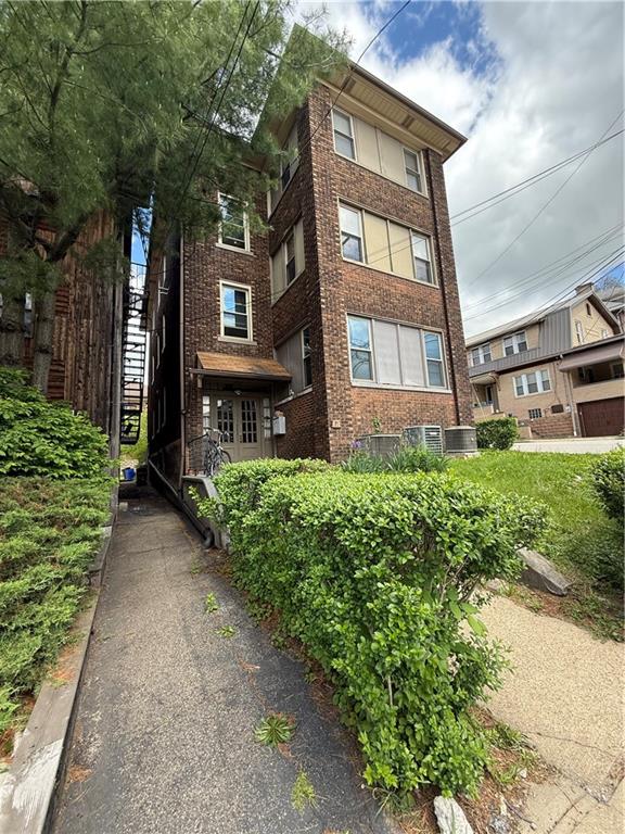 a view of a brick house with a yard