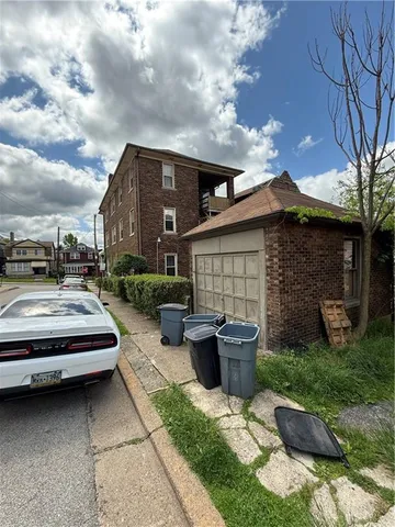 a view of house with yard outdoor seating area and barbeque oven