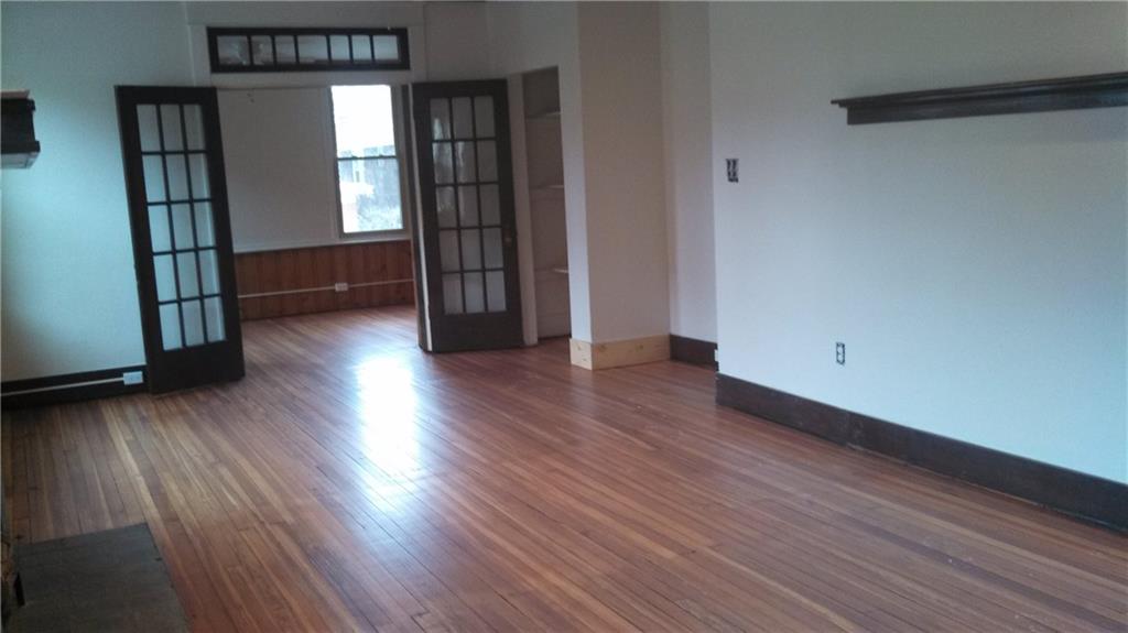17 Lenox Avenue Pittsburgh, PA 15221 - Photo 6 of 10 an empty room with wooden floor and windows