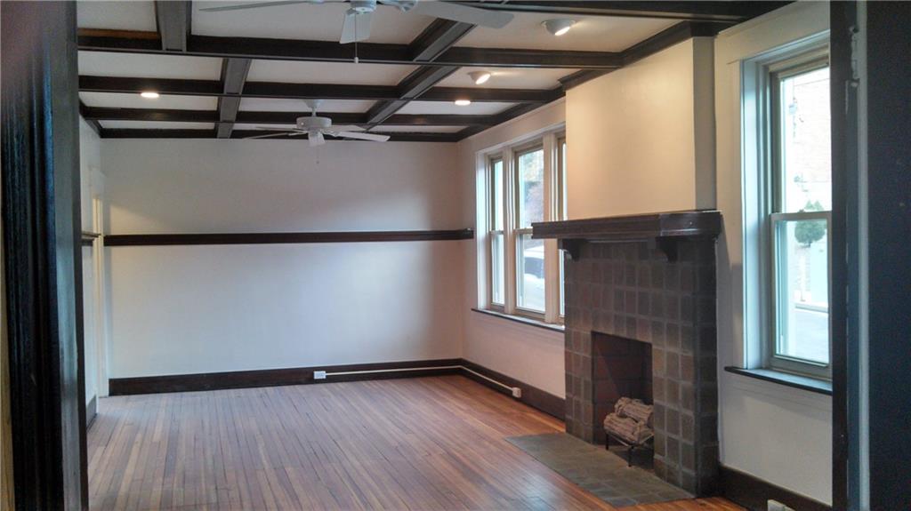 17 Lenox Avenue Pittsburgh, PA 15221 - Photo 8 of 10 a view of empty room with wooden floor and fan