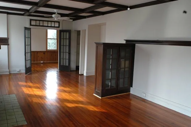 a view of hallway with stairs and wooden floor