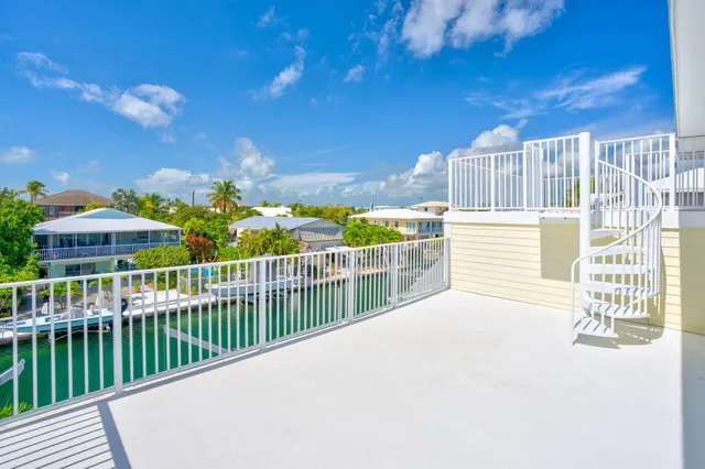 a view of a chair and tables in the back yard of the house