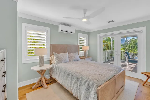 a bedroom with a bed and a table in it with window