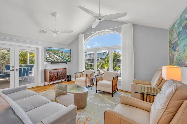a living room with furniture ceiling fan and a window