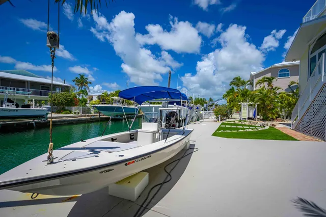 an aerial view of a house with swimming pool patio and outdoor seating