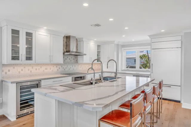 a kitchen with stainless steel appliances granite countertop a sink and a white cabinets
