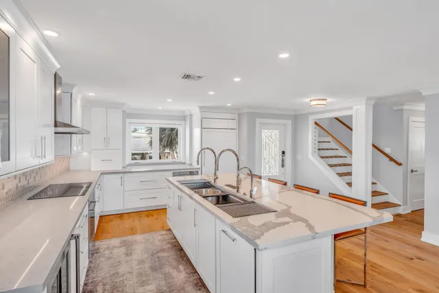 a kitchen with stainless steel appliances granite countertop a sink and cabinets