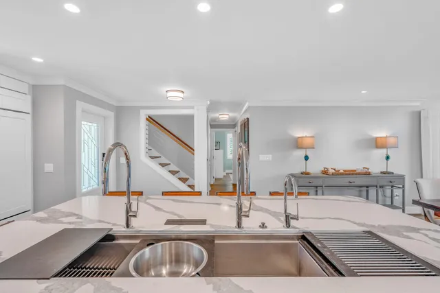 a large kitchen with stainless steel appliances granite countertop a sink and cabinets
