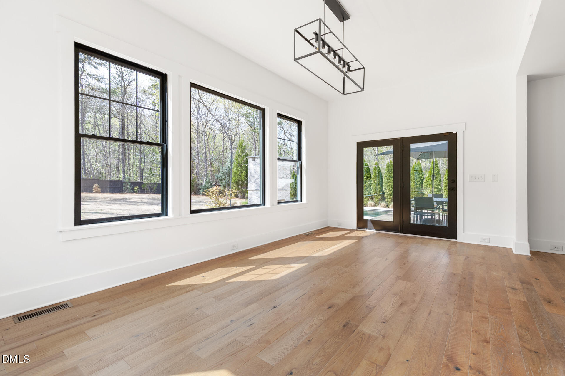 1117 Barley Stone Way Raleigh, NC 27603 - Photo 21 of 59 a view of an empty room with wooden floor and windows