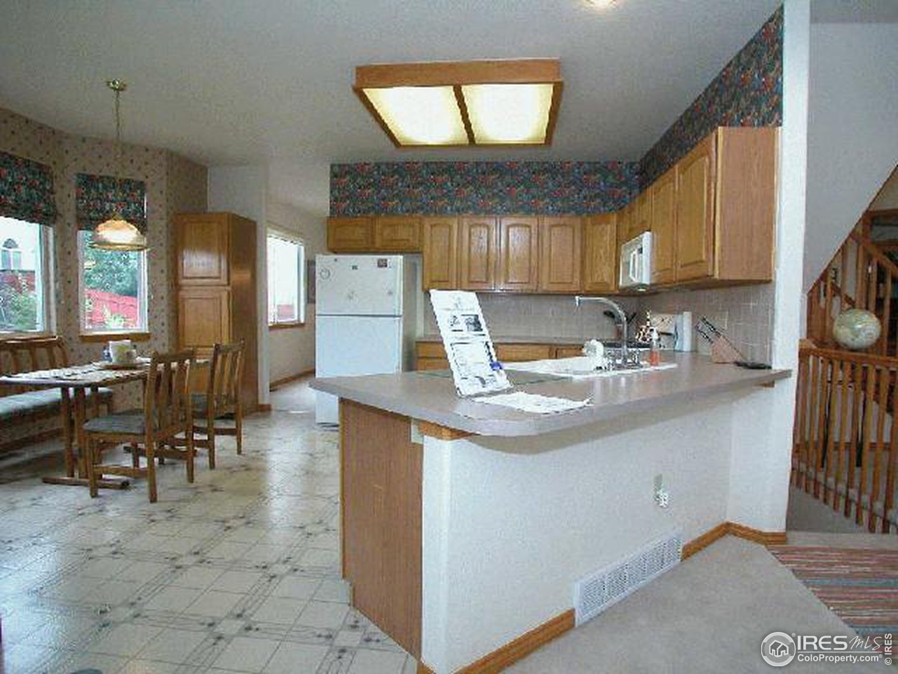 704 Rider Ridge Place Longmont, CO 80504 - Photo 2 of 12 a kitchen with granite countertop a sink a stove and cabinets