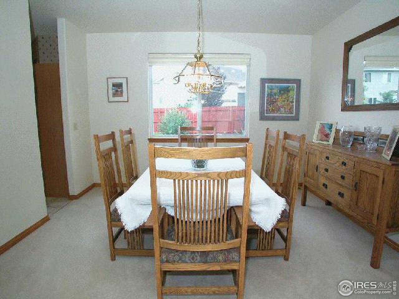 704 Rider Ridge Place Longmont, CO 80504 - Photo 6 of 12 a living room with furniture and a chandelier