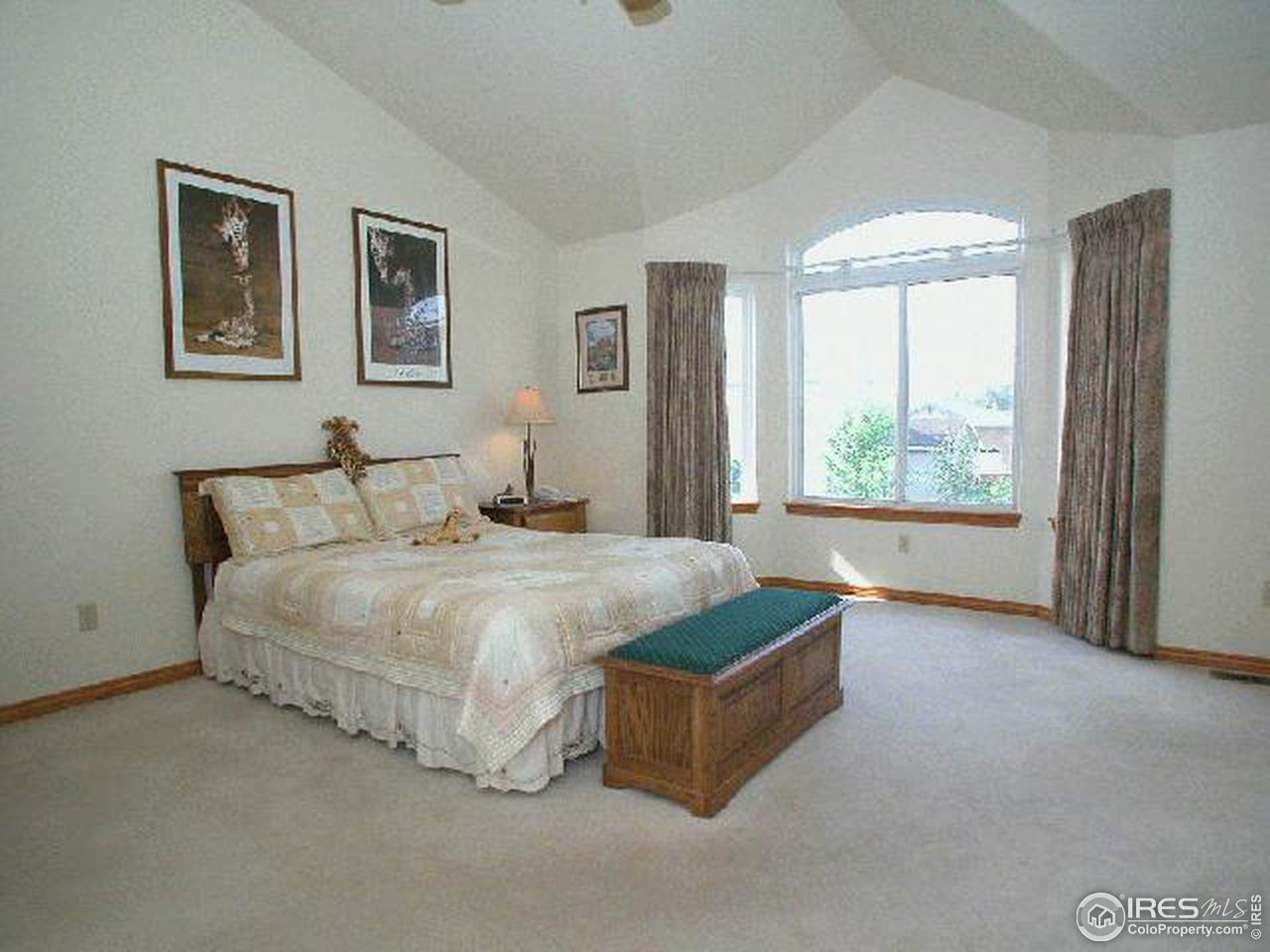 704 Rider Ridge Place Longmont, CO 80504 - Photo 8 of 12 a spacious bedroom with a bed and glass window