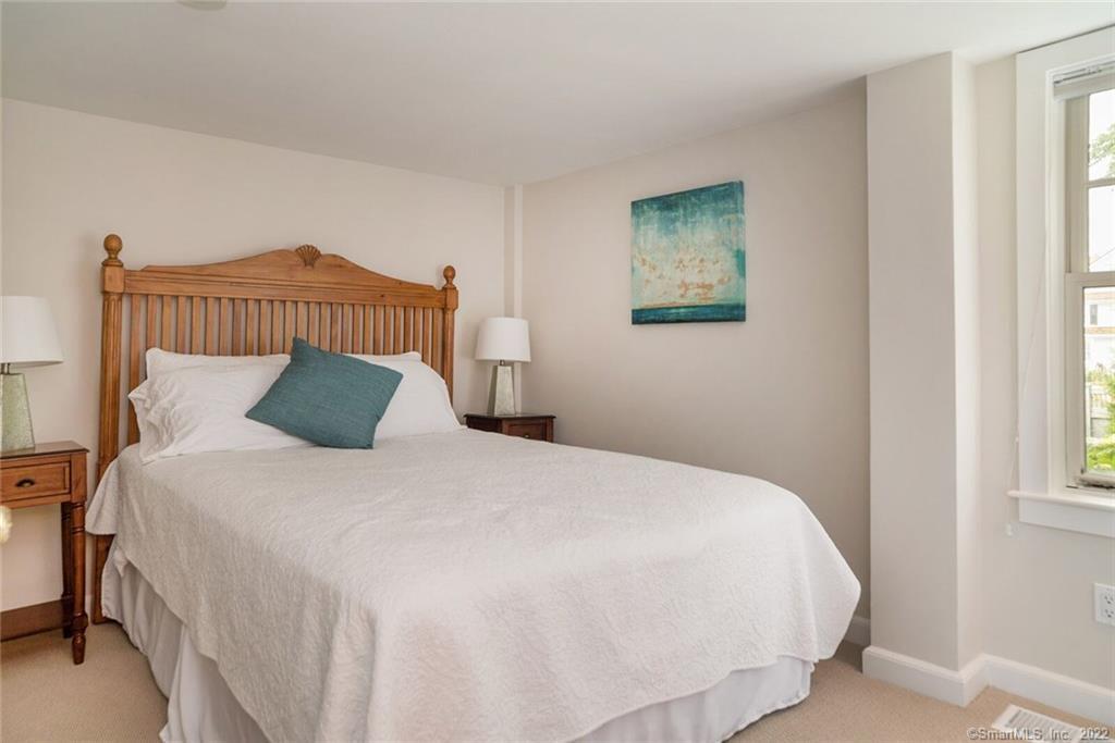 43 Soundview Avenue Madison, CT 06443 - Photo 14 of 31 a bedroom with a bed and a window