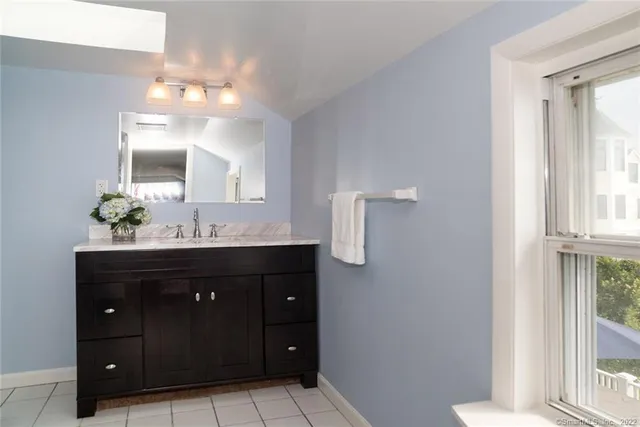 a bathroom with a sink vanity and mirror
