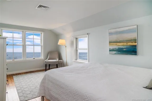 a bedroom with a bed and a large window