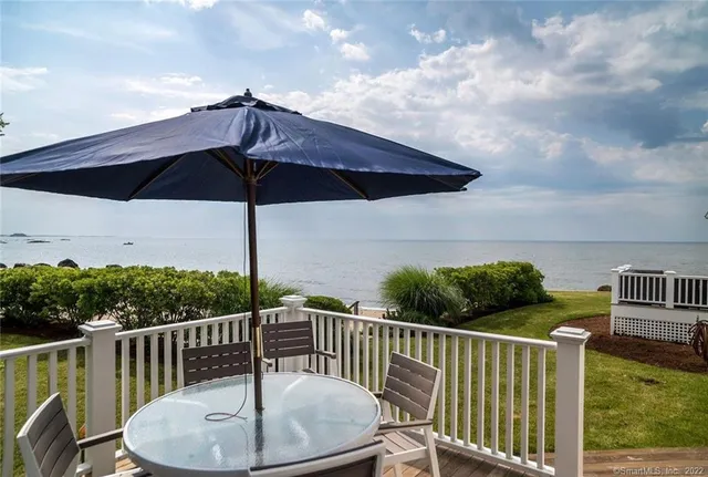 a view of balcony with furniture and umbrella
