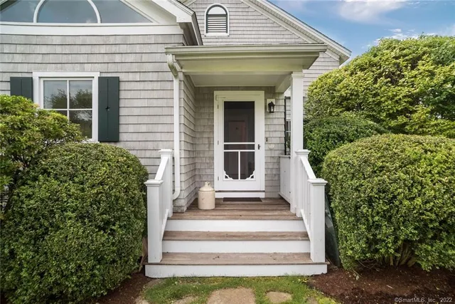 a front view of a house with plants