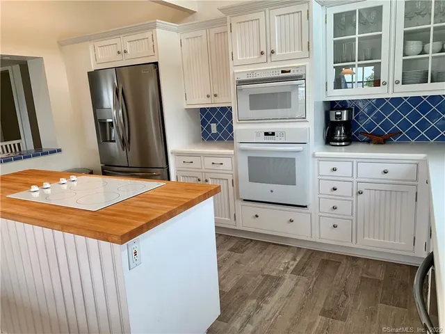 a kitchen with stainless steel appliances a stove sink and refrigerator