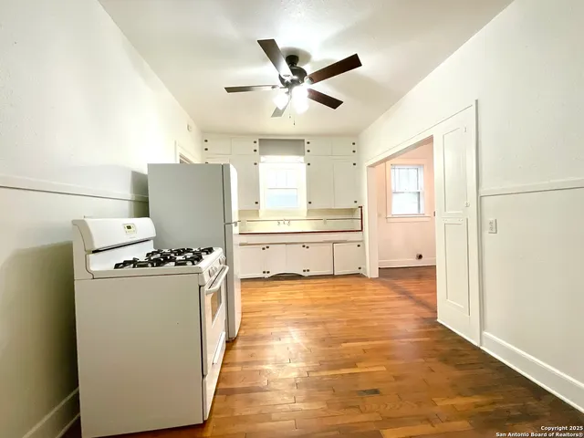 a view of a kitchen with a sink and a refrigerator