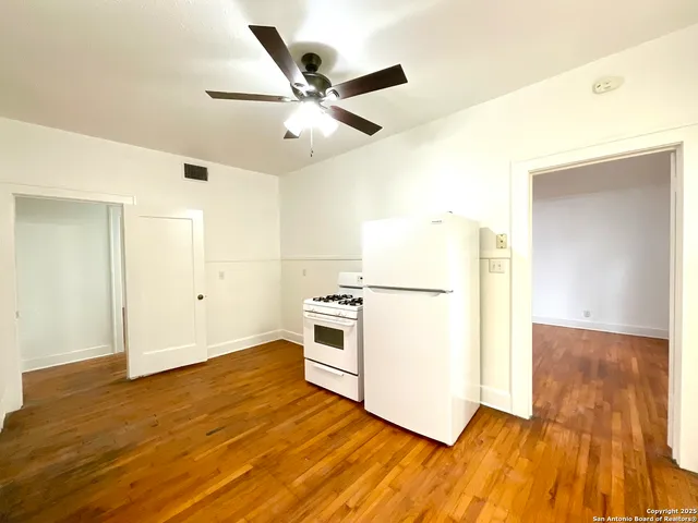 a view of kitchen with sink and wooden floor