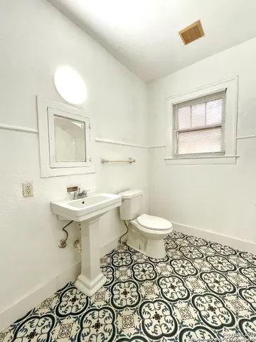 a view of a big room with wooden floor and fan in a room