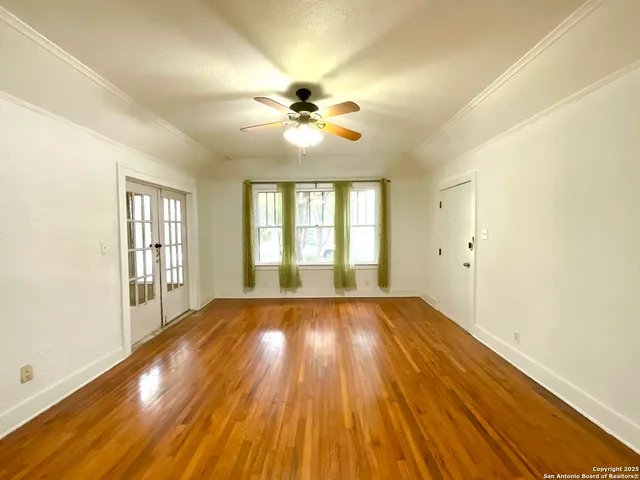 a view of a field with a tree in the background