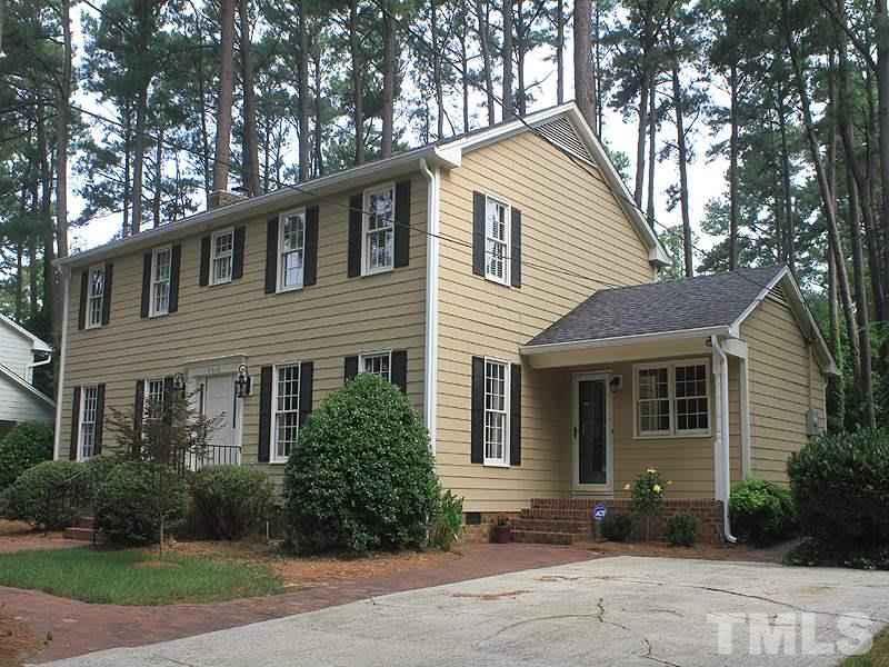 5016 Stonehill Drive Raleigh, NC 27609 - Photo 2 of 22 a front view of a house with a garden and plants