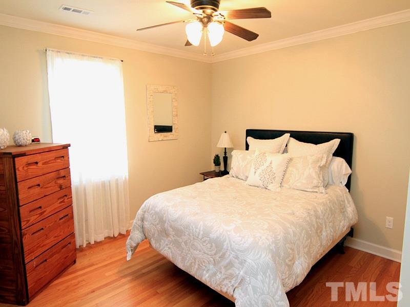 5016 Stonehill Drive Raleigh, NC 27609 - Photo 13 of 22 a bedroom with a bed and a dresser