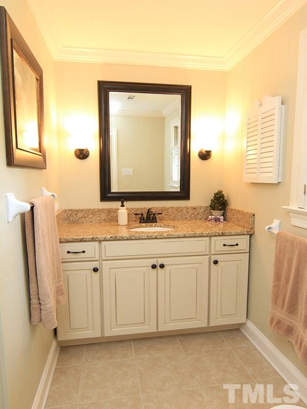 5016 Stonehill Drive Raleigh, NC 27609 - Photo 14 of 22 a bathroom with a granite countertop sink and a mirror