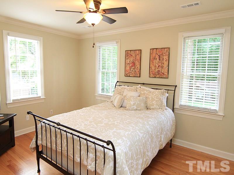 5016 Stonehill Drive Raleigh, NC 27609 - Photo 17 of 22 a bedroom with a bed and a window