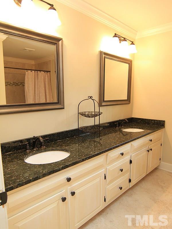 5016 Stonehill Drive Raleigh, NC 27609 - Photo 19 of 22 a bathroom with a granite countertop double vanity sink and mirror