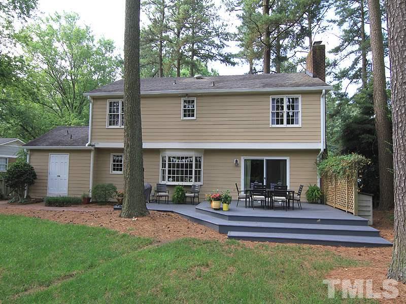 5016 Stonehill Drive Raleigh, NC 27609 - Photo 21 of 22 a view of a house with a patio and a yard
