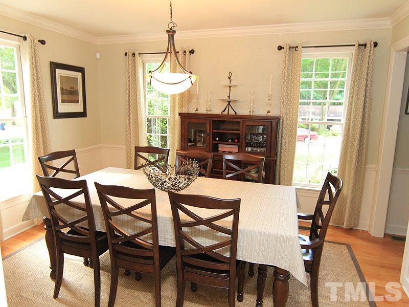 5016 Stonehill Drive Raleigh, NC 27609 - Photo 5 of 22 a view of a dining room with furniture window and wooden floor