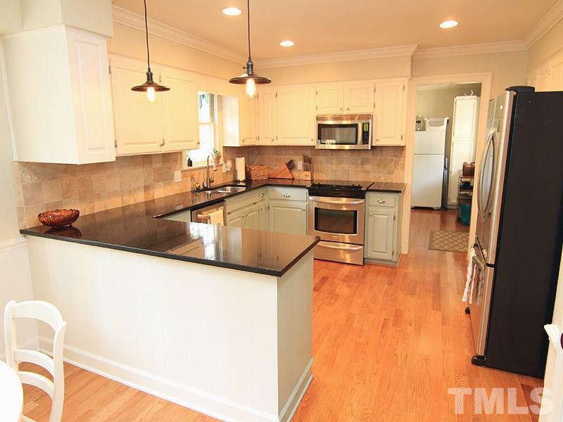 5016 Stonehill Drive Raleigh, NC 27609 - Photo 6 of 22 a kitchen with stainless steel appliances granite countertop a refrigerator a stove and a sink