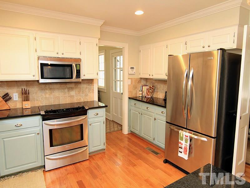 5016 Stonehill Drive Raleigh, NC 27609 - Photo 7 of 22 a kitchen with stainless steel appliances a refrigerator stove and microwave