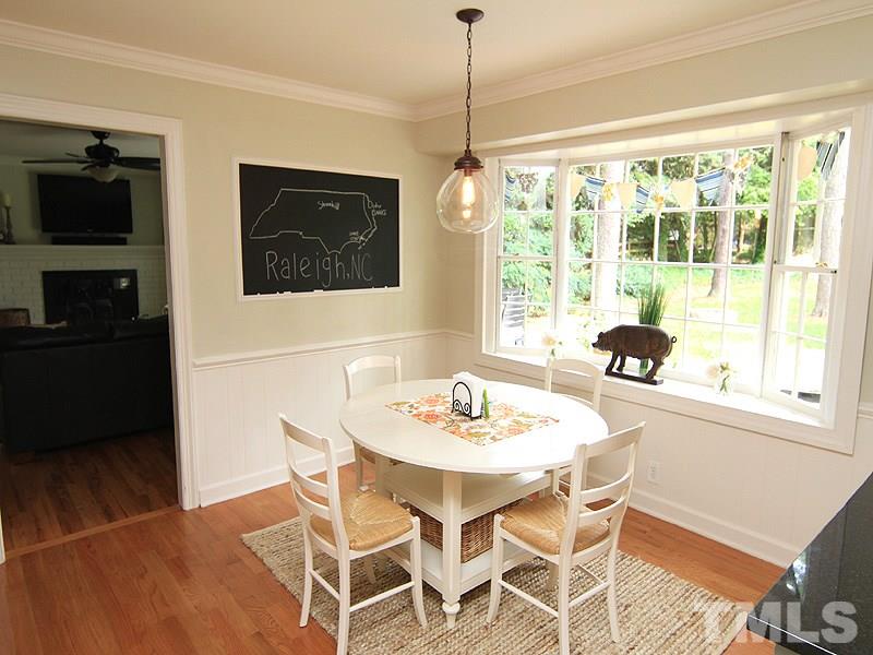 5016 Stonehill Drive Raleigh, NC 27609 - Photo 8 of 22 a view of a dining room with furniture window and outside view