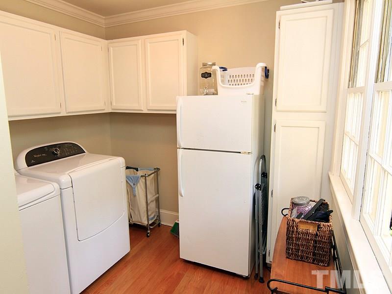 5016 Stonehill Drive Raleigh, NC 27609 - Photo 9 of 22 a white refrigerator freezer and a stove sitting inside of a kitchen