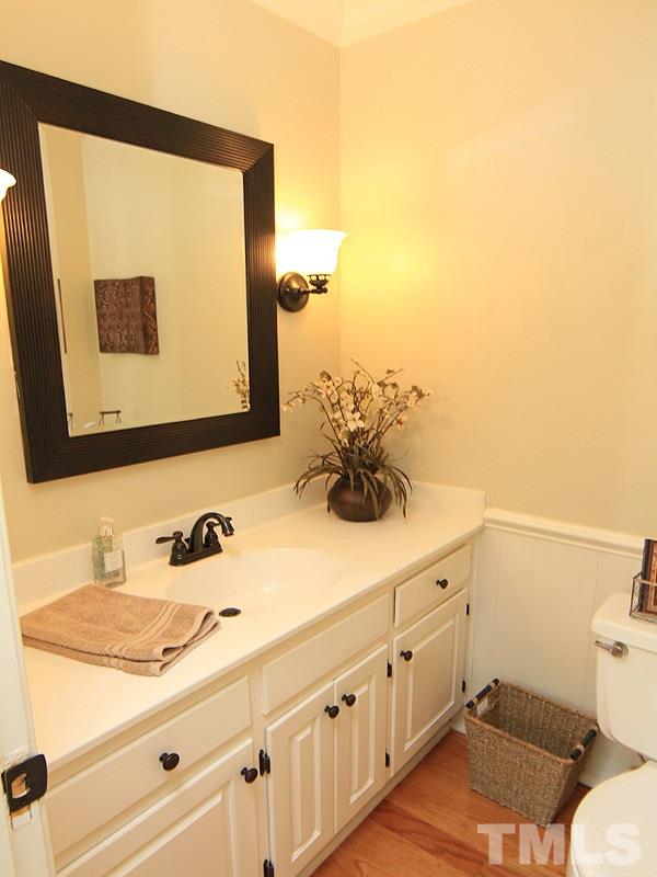 5016 Stonehill Drive Raleigh, NC 27609 - Photo 10 of 22 a bathroom with a sink and a mirror