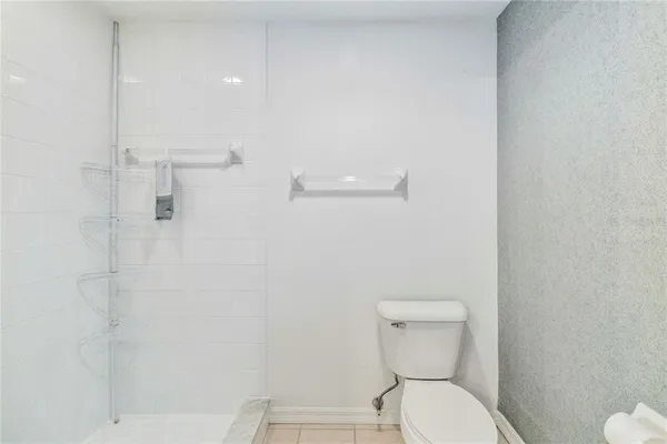 a white toilet sitting next to a bathroom sink