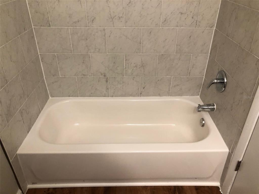 6818 Southwest 42nd Place, Unit D Gainesville, FL 32608 - Photo 12 of 16 a bathroom with a bathtub