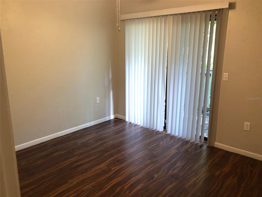6818 Southwest 42nd Place, Unit D Gainesville, FL 32608 - Photo 13 of 16 a view of a room with wooden floor and a window