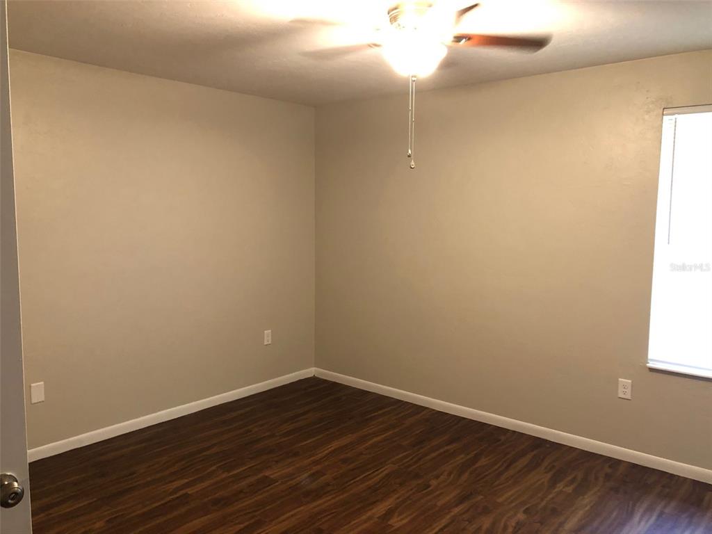 6818 Southwest 42nd Place, Unit D Gainesville, FL 32608 - Photo 10 of 16 wooden floor in an empty room