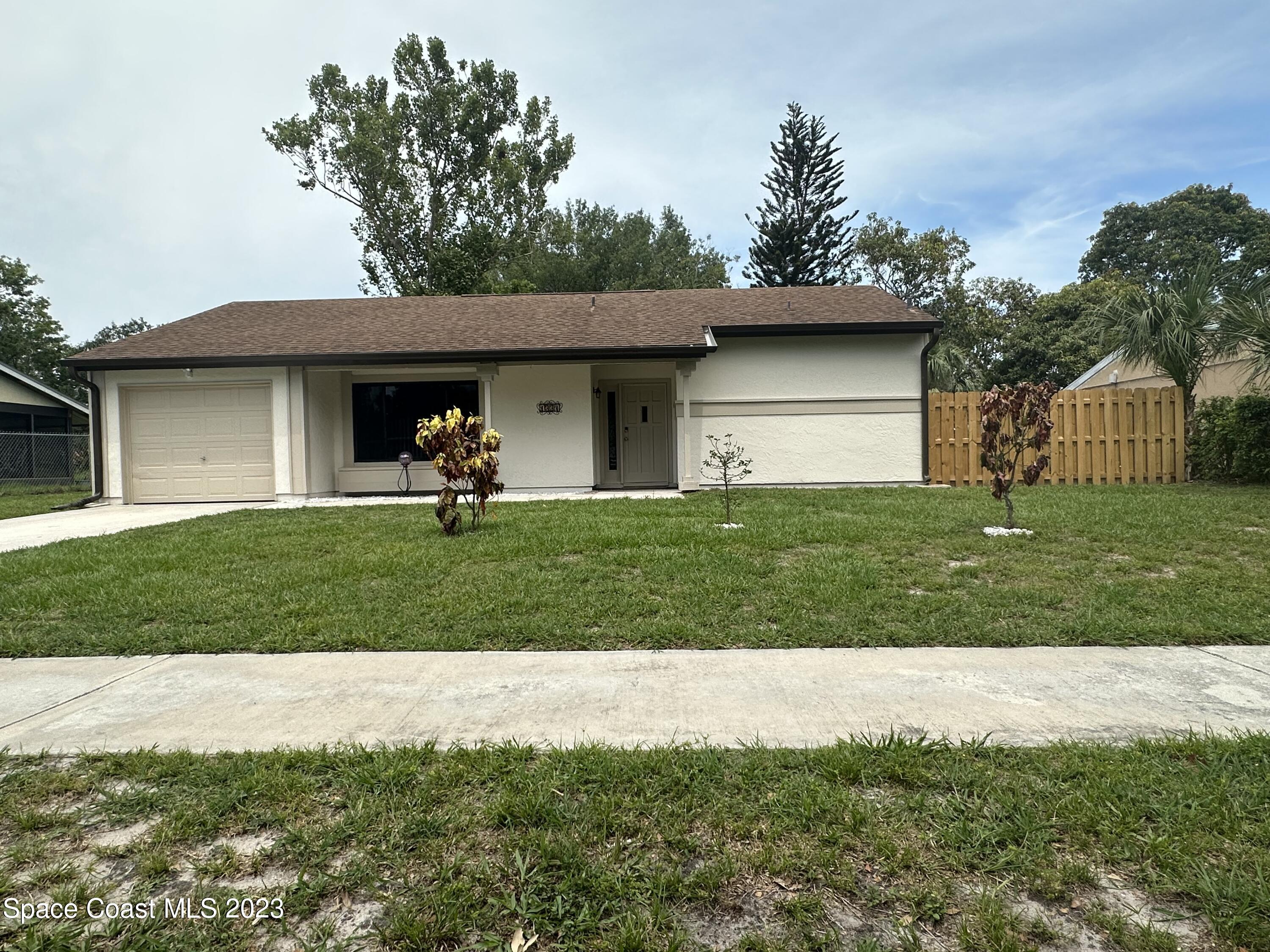 1331 Creel Road Northeast Palm Bay, FL 32905 - Photo 1 of 21 a front view of a house with a yard