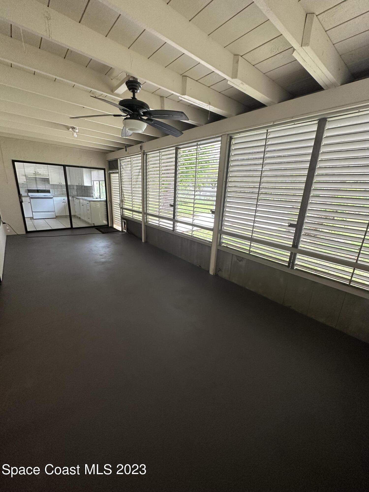 1331 Creel Road Northeast Palm Bay, FL 32905 - Photo 11 of 21 a view of an empty room with a ceiling fan
